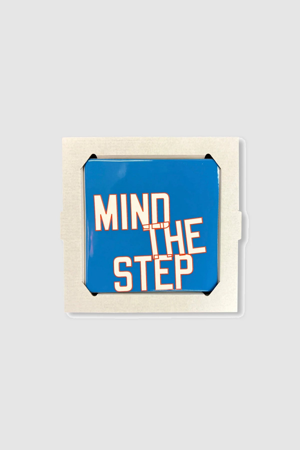 MIND THE STEP - GLAZED CERAMIC TILE by Lawrence Weiner