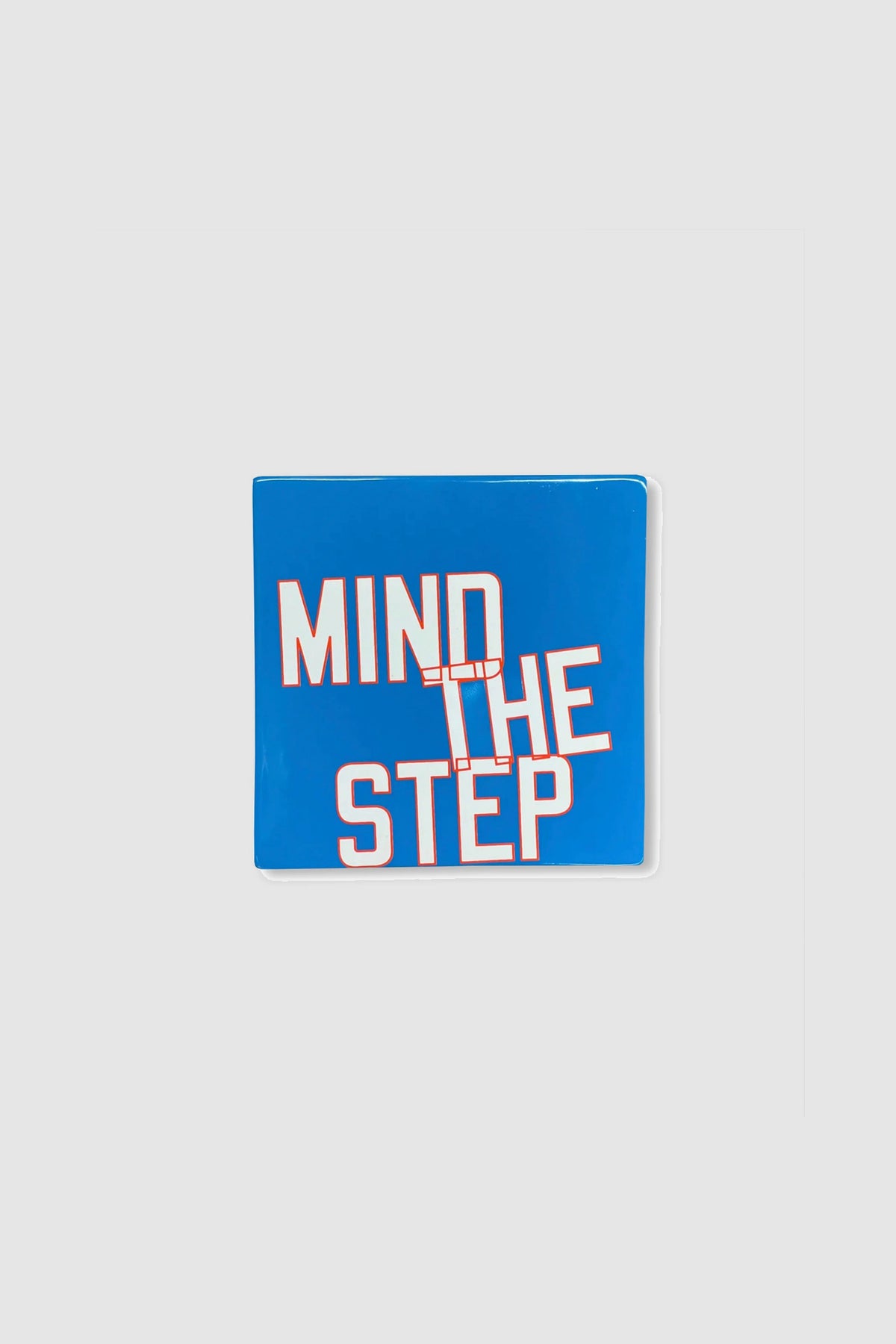 MIND THE STEP - GLAZED CERAMIC TILE by Lawrence Weiner